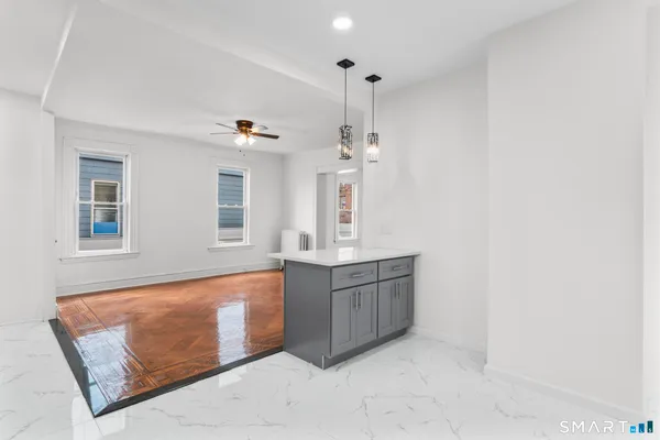 a view interior of kitchen and hall with wooden floor