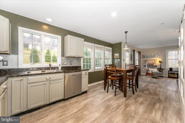 a kitchen with stainless steel appliances granite countertop a sink and cabinets