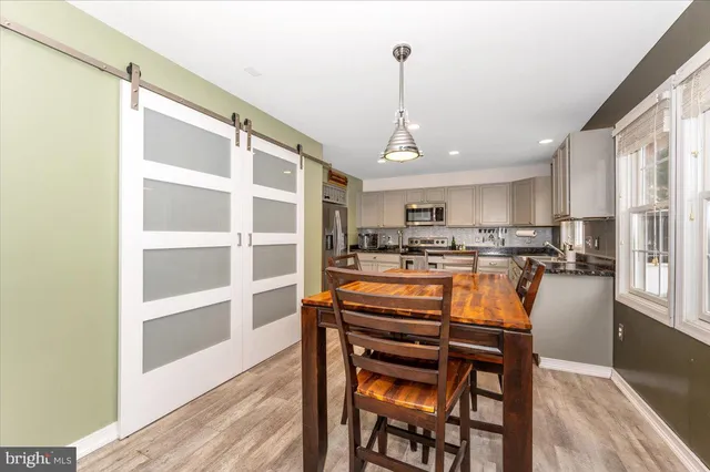 a living room with furniture and paintings on the wall
