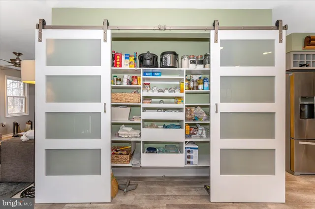 a view of a hallway with windows and couches