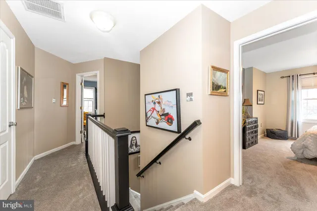 a en suite bathroom with a granite countertop sink and a mirror