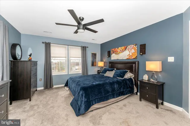 a bathroom with a double vanity sink a mirror and a bathtub