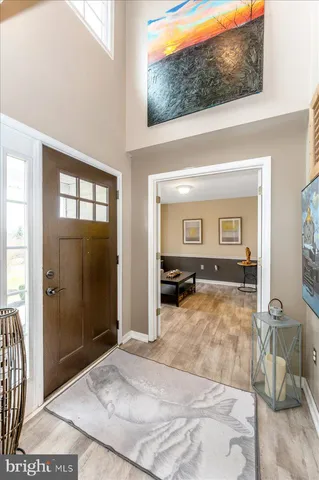 a view of entryway and hall with wooden floor