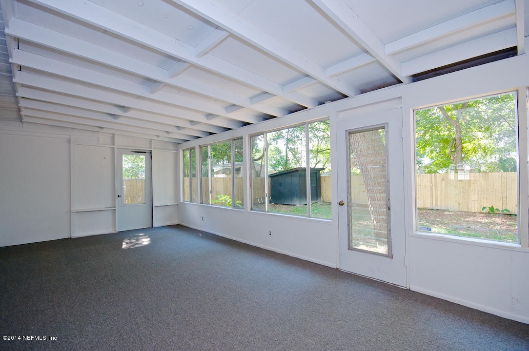 5614 Stetson Road Jacksonville, FL 32207 - Photo 15 of 20 a view of an empty room with windows and view of bedroom