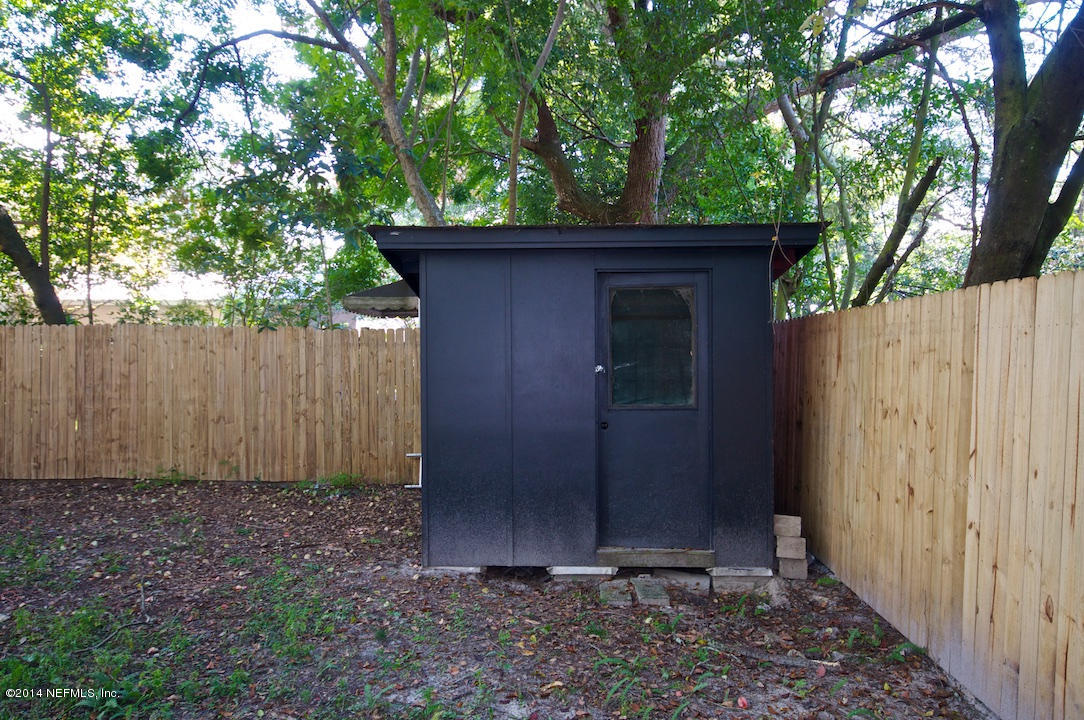 5614 Stetson Road Jacksonville, FL 32207 - Photo 19 of 20 a wooden door in front of a house