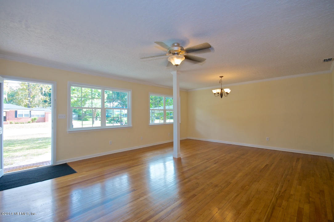5614 Stetson Road Jacksonville, FL 32207 - Photo 4 of 20 a view of an empty room with a window and wooden floor