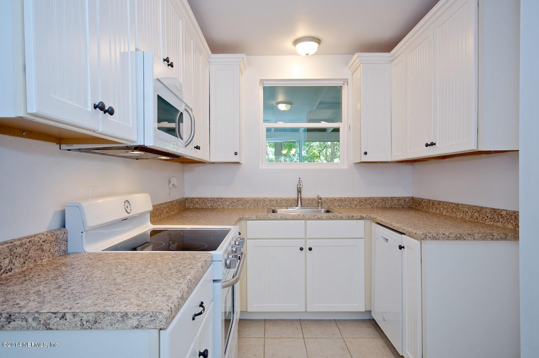 5614 Stetson Road Jacksonville, FL 32207 - Photo 7 of 20 a kitchen with stainless steel appliances granite countertop a sink and a white cabinets