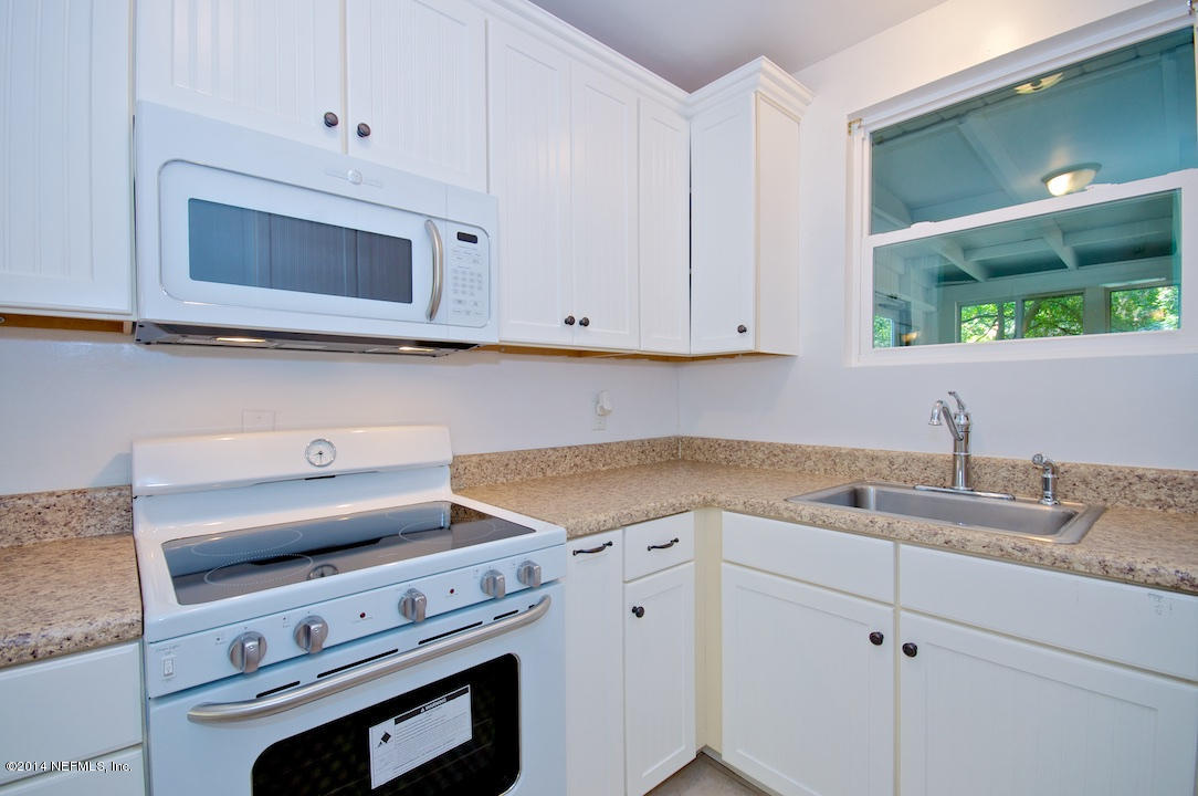 5614 Stetson Road Jacksonville, FL 32207 - Photo 8 of 20 a kitchen with granite countertop white cabinets and a stove