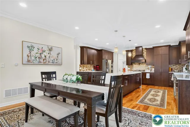 a living room with furniture a fireplace and a potted plant