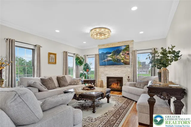 a view of a livingroom with furniture wooden floor and windows