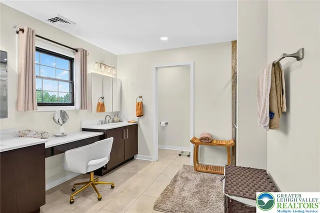 a bed room with a bed and a chair