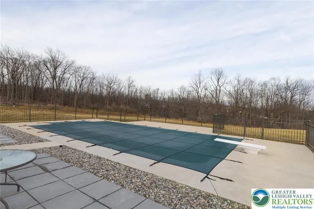 a view of swimming pool with trees in the background