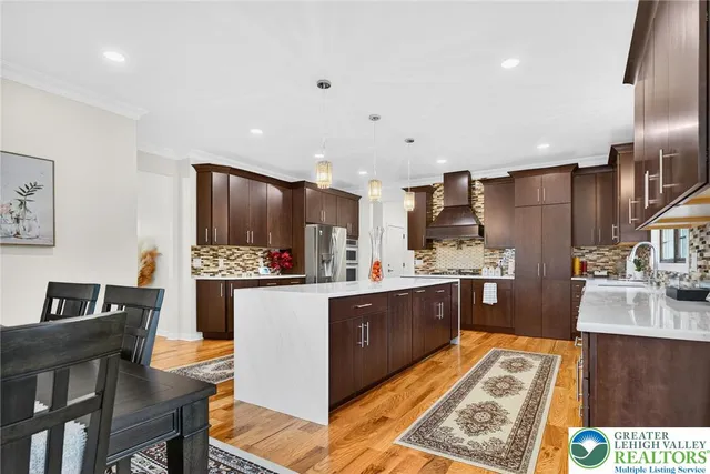 a living room with stainless steel appliances kitchen island granite countertop furniture and a view of kitchen