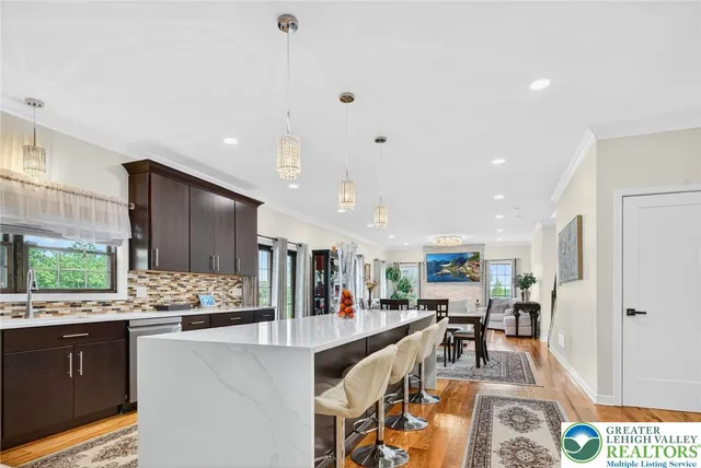 a living room with stainless steel appliances kitchen island granite countertop furniture and a dining table