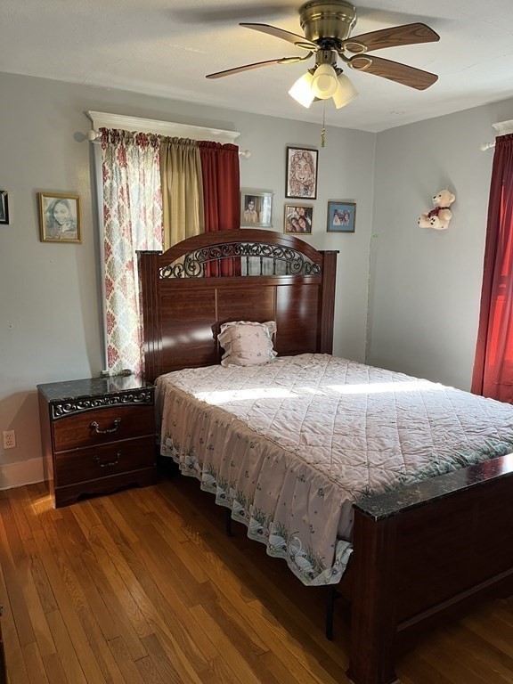 111 Wilber Street Springfield, MA 01104 - Photo 15 of 26 a large bed sitting in a bedroom next to a window