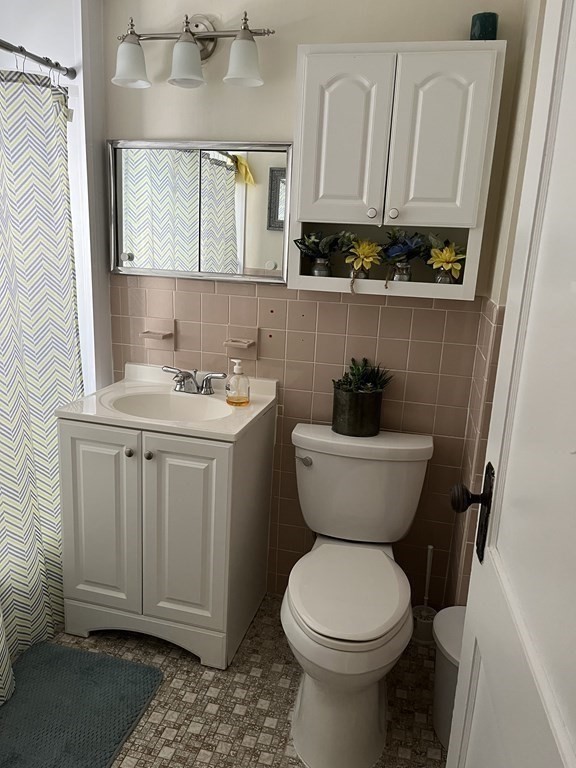 111 Wilber Street Springfield, MA 01104 - Photo 16 of 26 a bathroom with a toilet a sink and a window