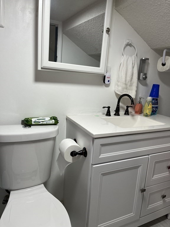 111 Wilber Street Springfield, MA 01104 - Photo 23 of 26 a bathroom with a toilet sink and mirror