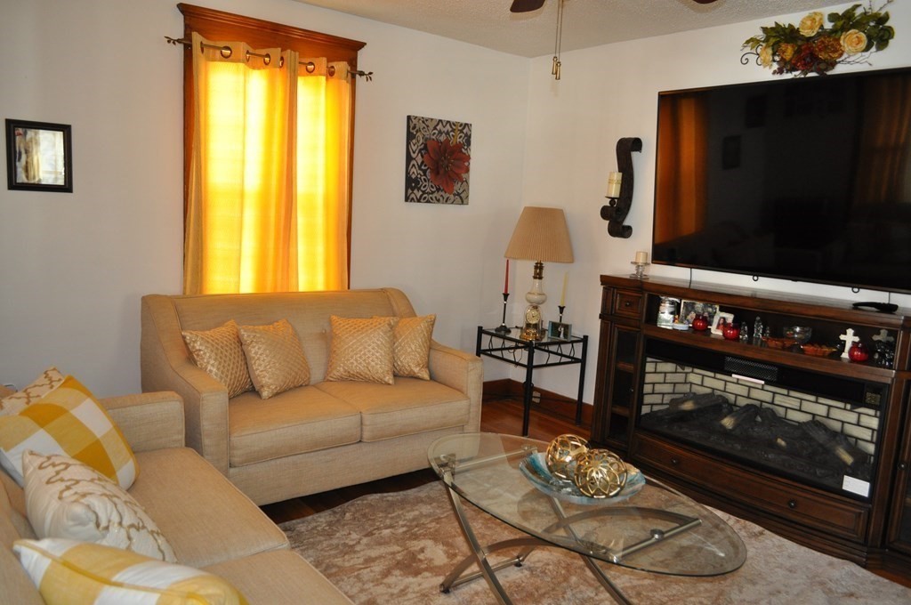 111 Wilber Street Springfield, MA 01104 - Photo 4 of 26 a living room with furniture a flat screen tv and a window