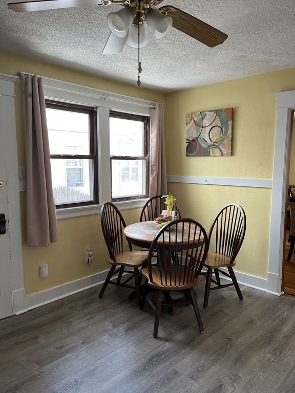 111 Wilber Street Springfield, MA 01104 - Photo 9 of 26 a dining room with furniture a chandelier and wooden floor