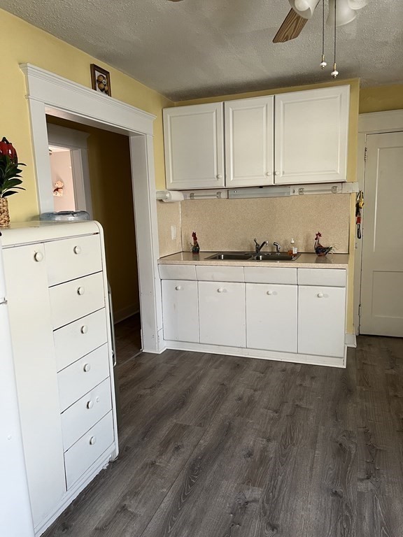 111 Wilber Street Springfield, MA 01104 - Photo 10 of 26 a kitchen with white cabinets and window