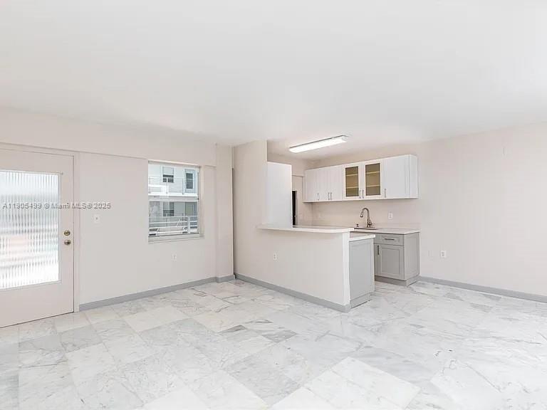 1545 Euclid Avenue, Unit 2D Miami Beach, FL 33139 - Photo 12 of 23 a view of a kitchen with a sink and a refrigerator