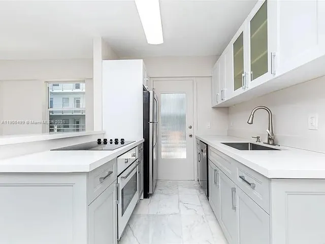 a kitchen with a sink stove and refrigerator
