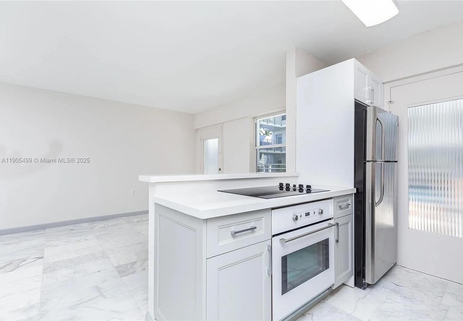 1545 Euclid Avenue, Unit 2D Miami Beach, FL 33139 - Photo 17 of 23 a kitchen with a stove sink and refrigerator