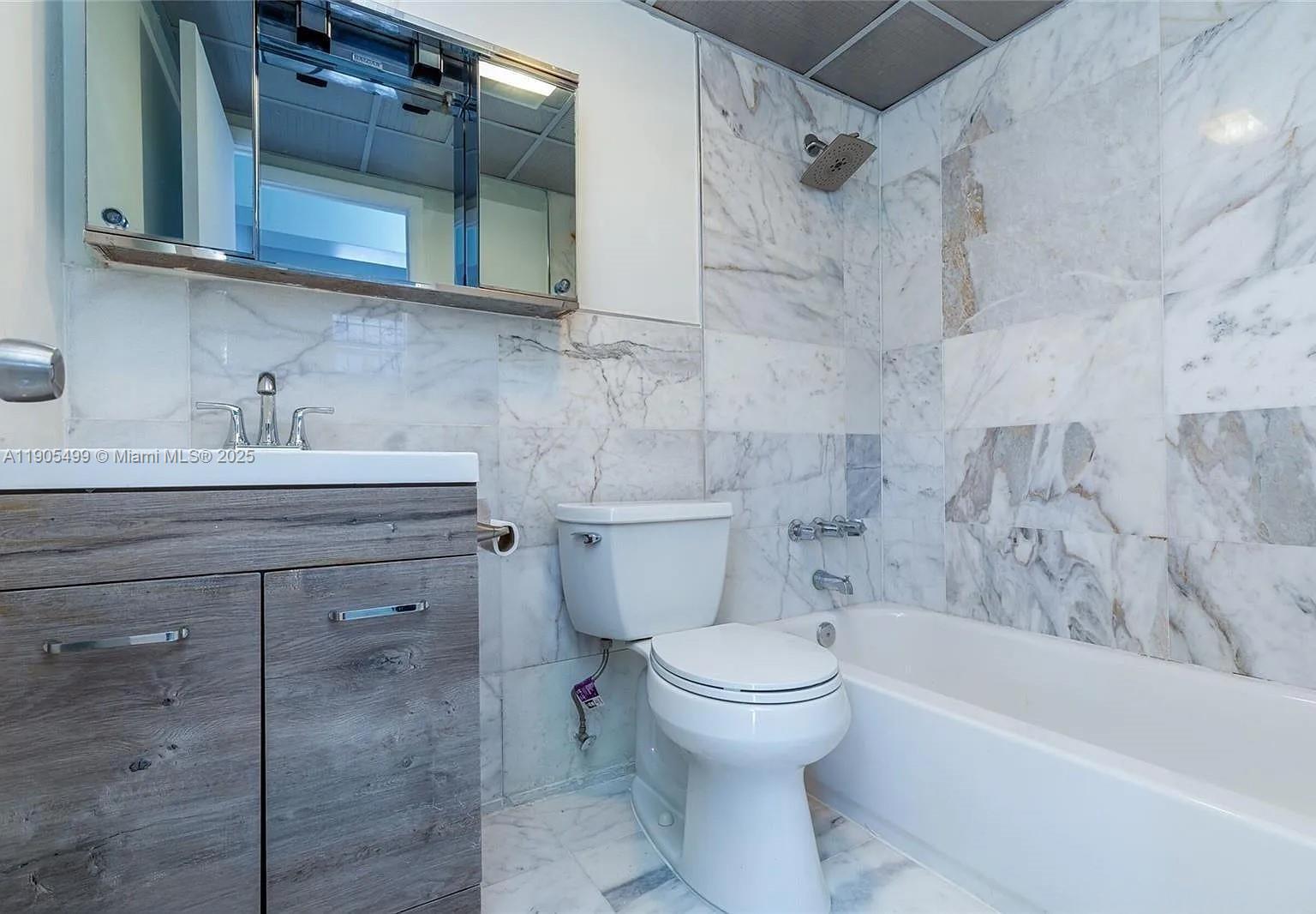 1545 Euclid Avenue, Unit 2D Miami Beach, FL 33139 - Photo 10 of 23 a bathroom with a sink toilet and shower