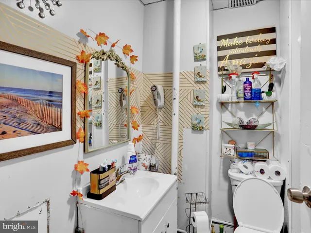 a bathroom with a sink a toilet and a shower curtain