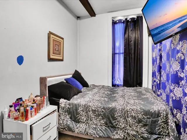 a bedroom with a bed and a window