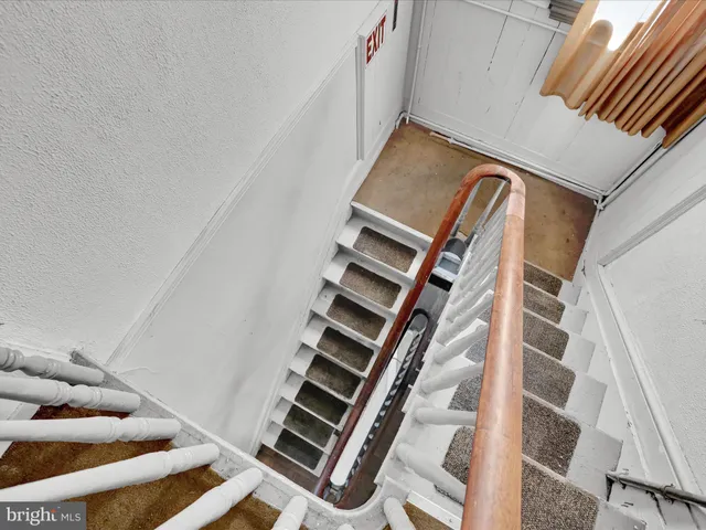 a view of staircase with wooden floor and shoes