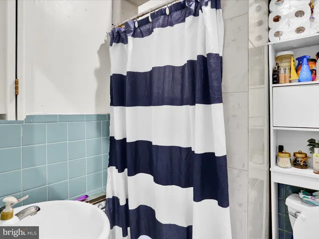 a bathroom with a sink and a shower curtain