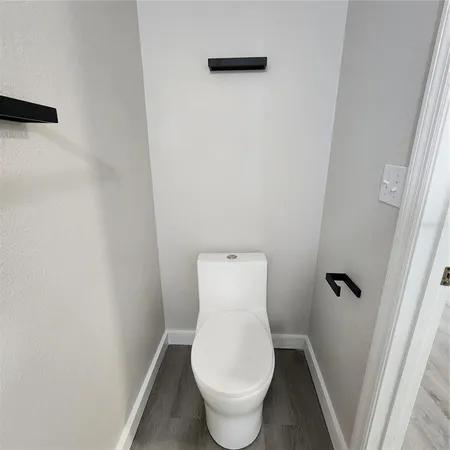 a view of a room with wooden floor and closet area