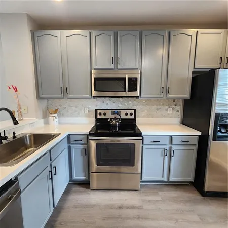 a stove top oven sitting inside of a kitchen