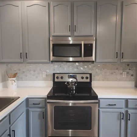 a kitchen with a refrigerator and window