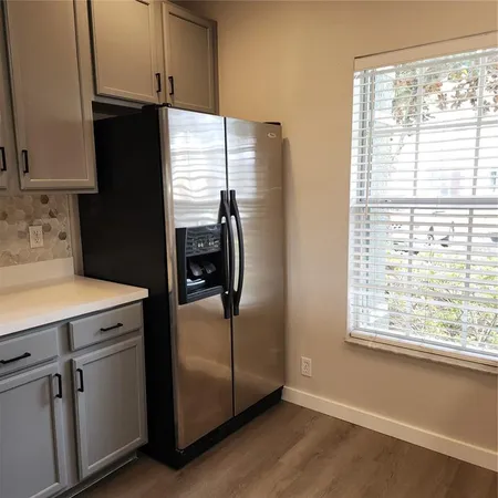 a view of a kitchen with wooden floor and a sink