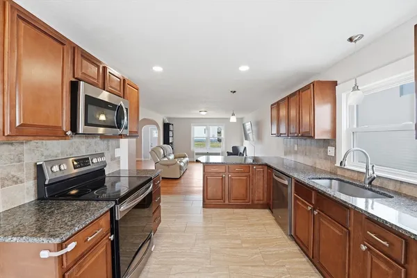 a spacious bedroom with a bed and wooden floor