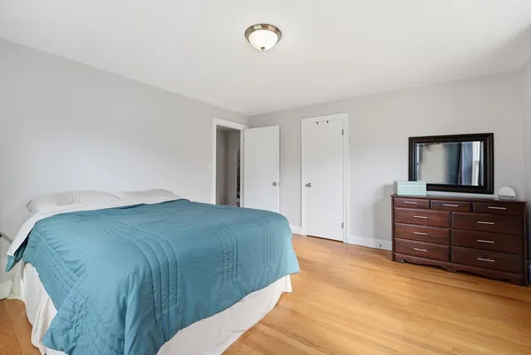 a view of a workspace with wooden floor and a window