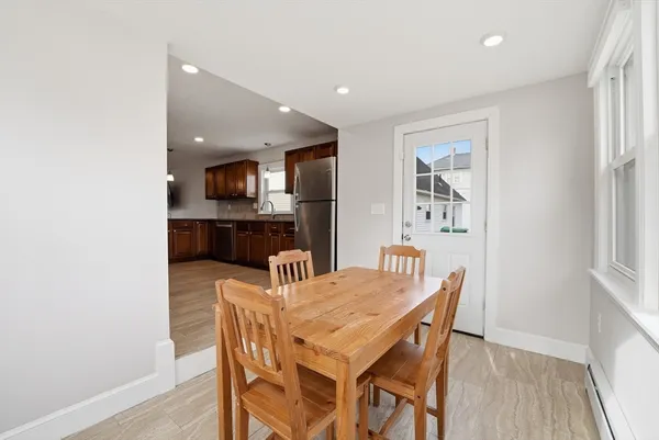 a view of a dining room with furniture large windows and wooden floor