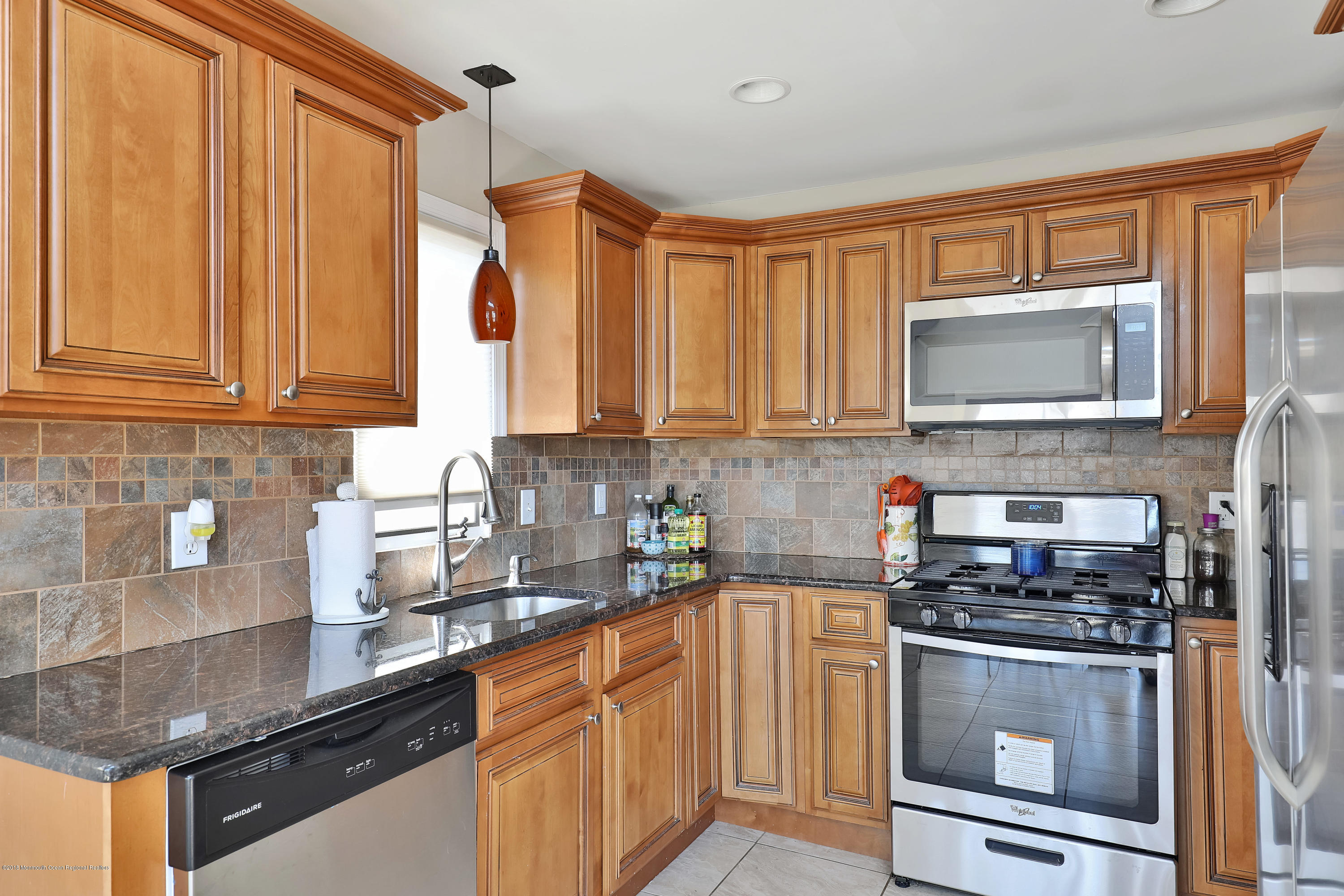 41 Club House Road Brick, NJ 08723 - Photo 11 of 33 a kitchen with stainless steel appliances granite countertop a stove a sink and a microwave