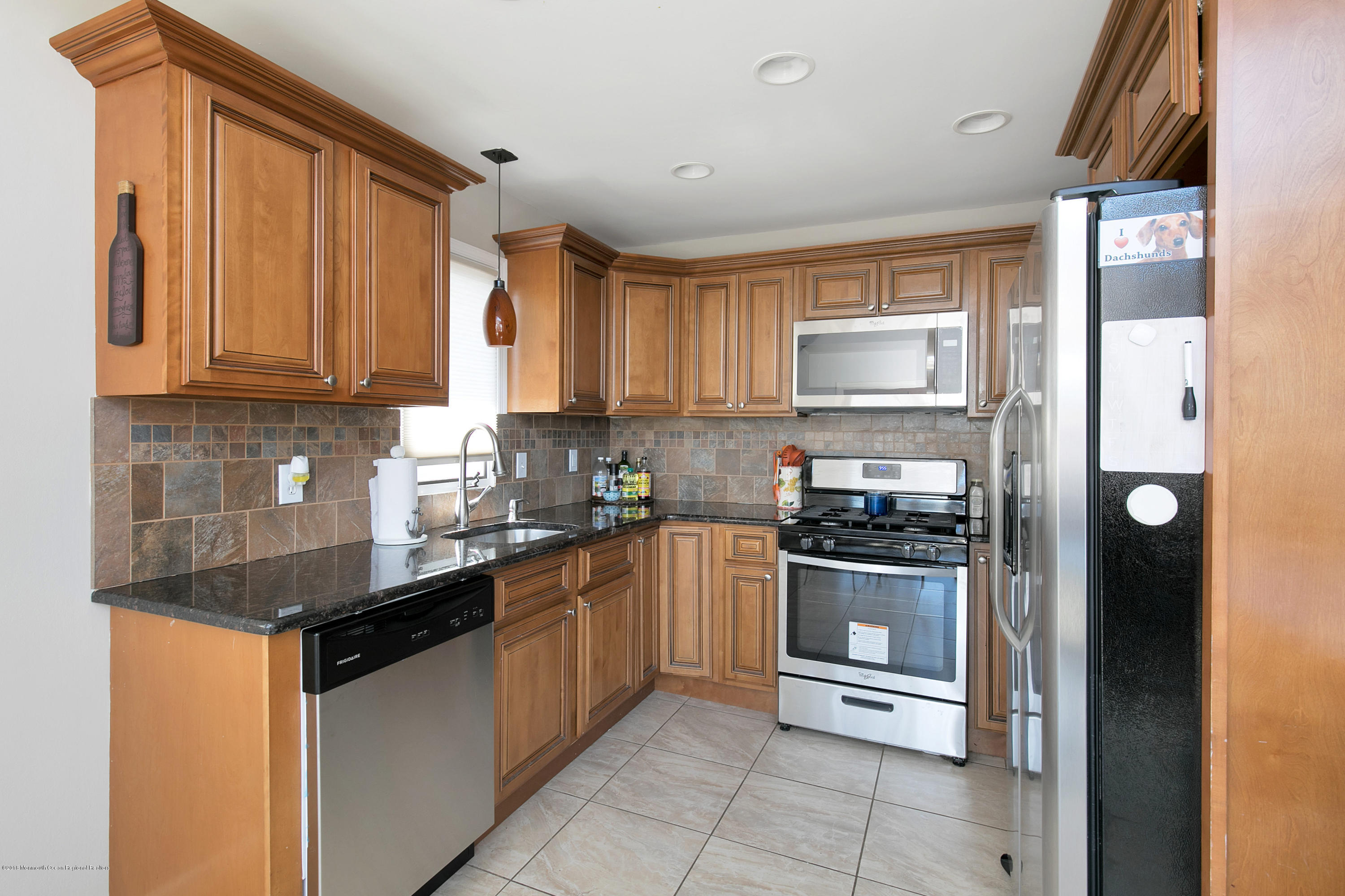 41 Club House Road Brick, NJ 08723 - Photo 10 of 33 a kitchen with stainless steel appliances granite countertop a stove a sink and a refrigerator