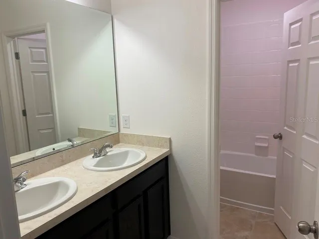 a white toilet sitting next to a bath tub