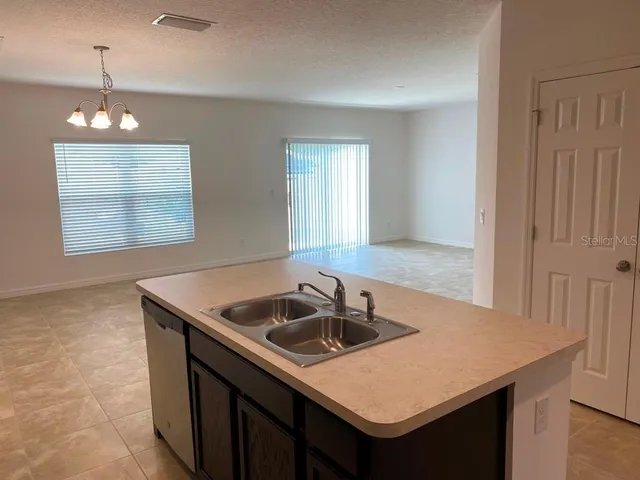 a kitchen with a sink a counter space and a window