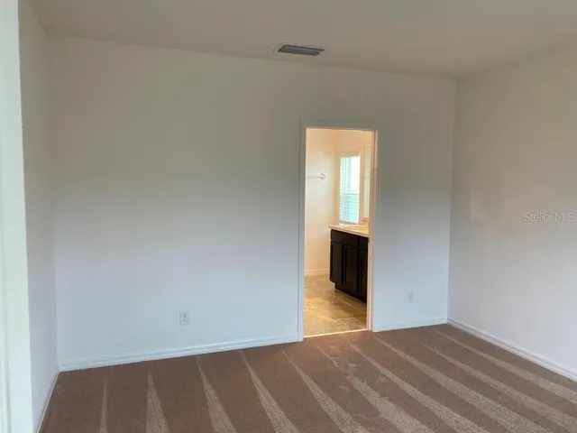 a view of a livingroom with wooden floor and staircase