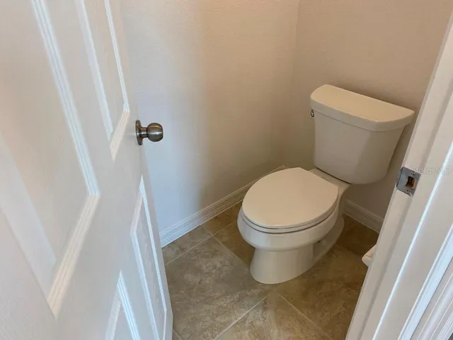 a white toilet sitting next to a sink