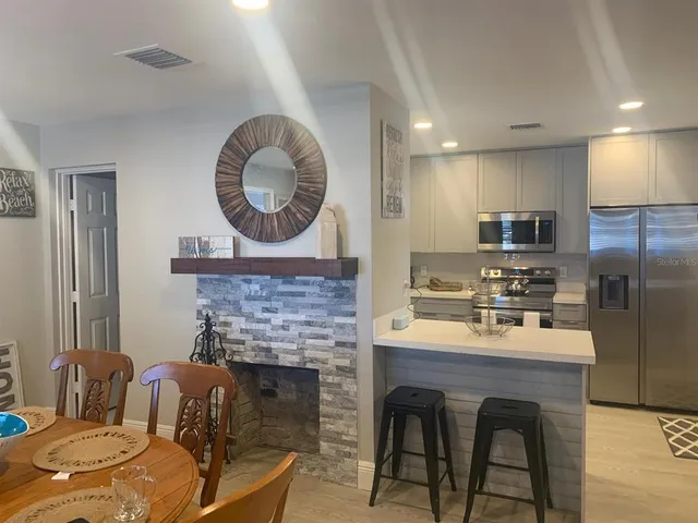 a view of a dining room with furniture and a chandelier