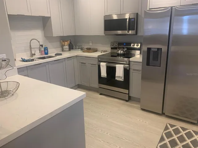 a living room with furniture a flat screen tv and a window