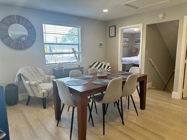 a living room with furniture a clock and a window