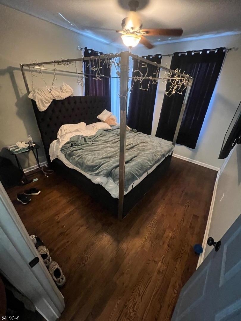 32 Augusta Street Irvington, NJ 07111 - Photo 2 of 10 a bed sitting in a bedroom next to a lamp