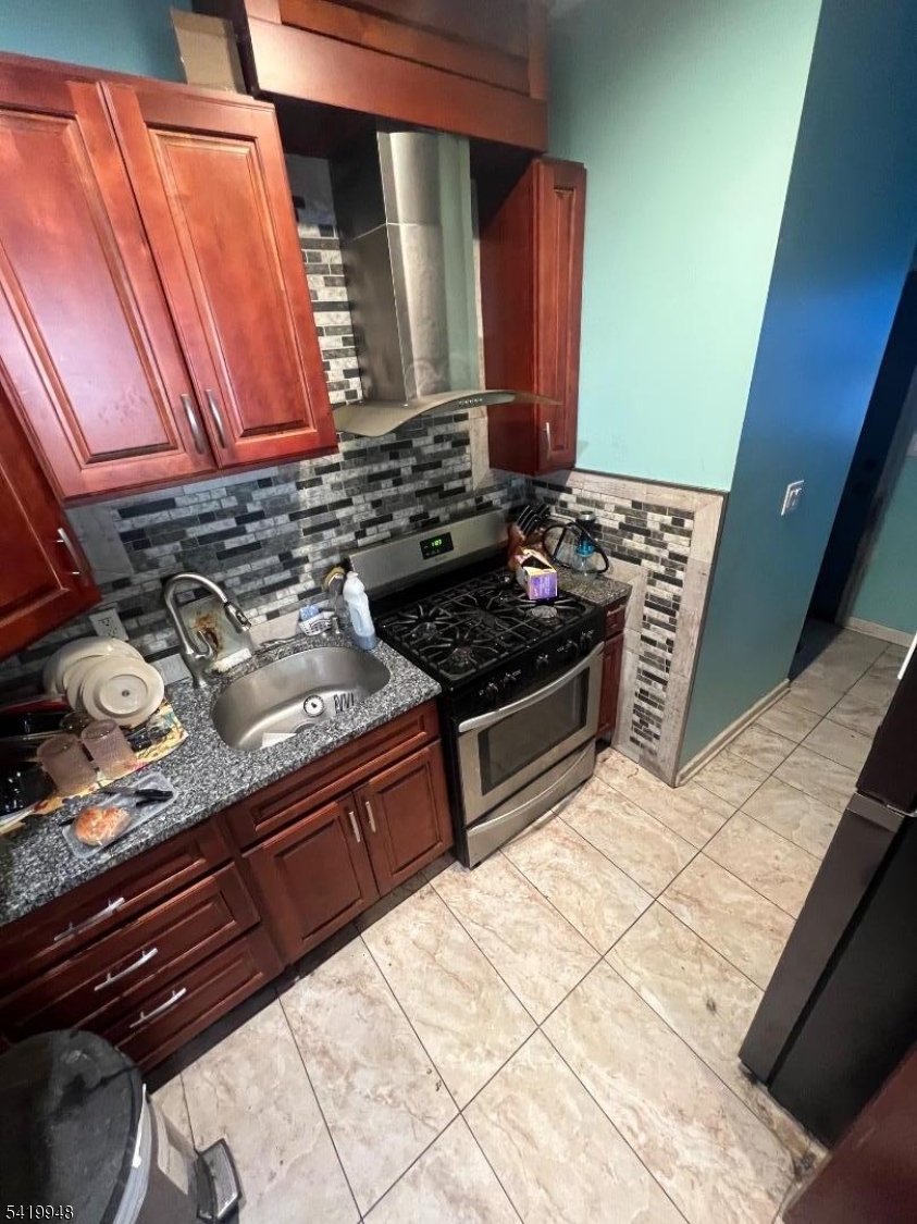32 Augusta Street Irvington, NJ 07111 - Photo 6 of 10 a kitchen with stainless steel appliances granite countertop a stove and a microwave oven